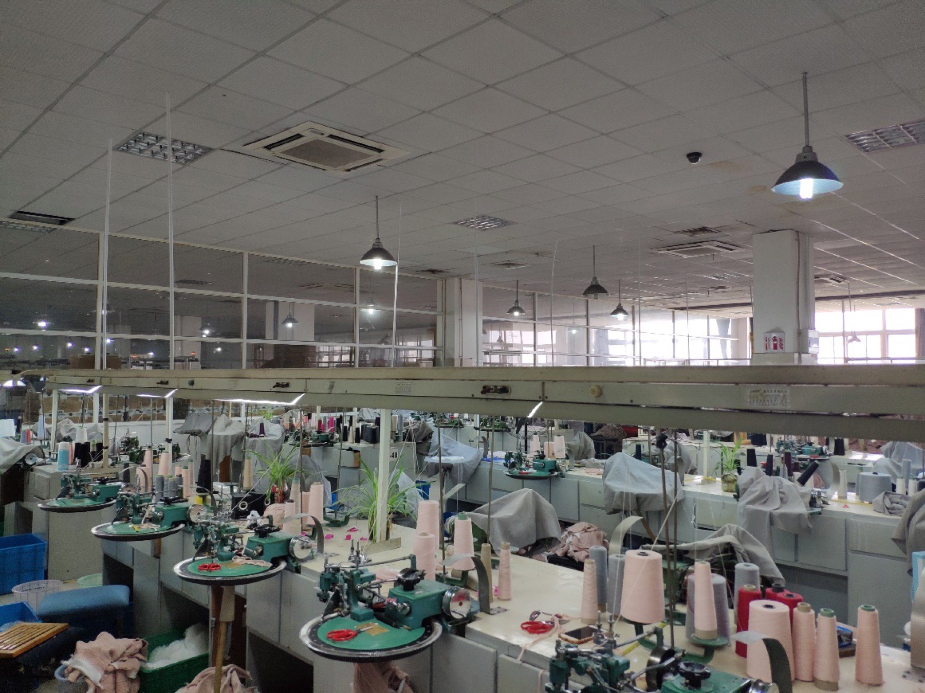 Rows of knitting and linking machines on the factory floor